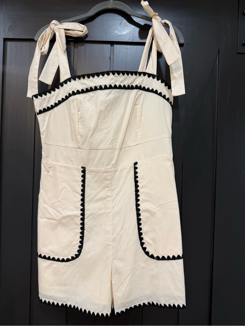 Womenโs Cream Tie-Shoulder One-Piece Romper with Black Trim